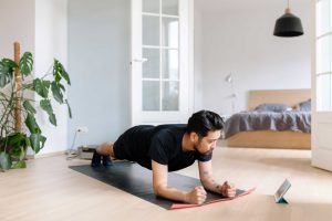 asian man uses digital tablet to lean plank royalty free image 1584377468